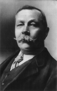 A black and white photograph of Sir Arthur Conan Doyle
