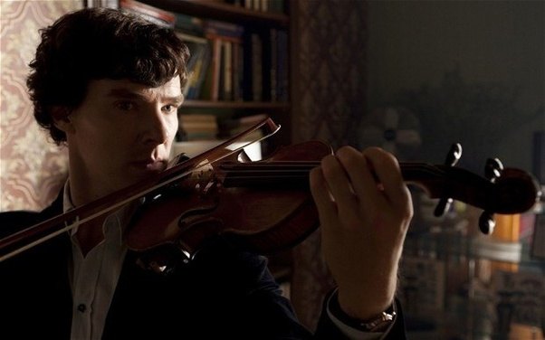 A photograph of Benedict Cumberbatch as Sherlock Holmes playing the violin.